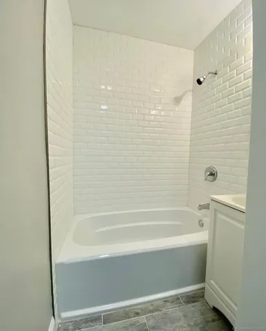 a bathroom with bathtub and shower