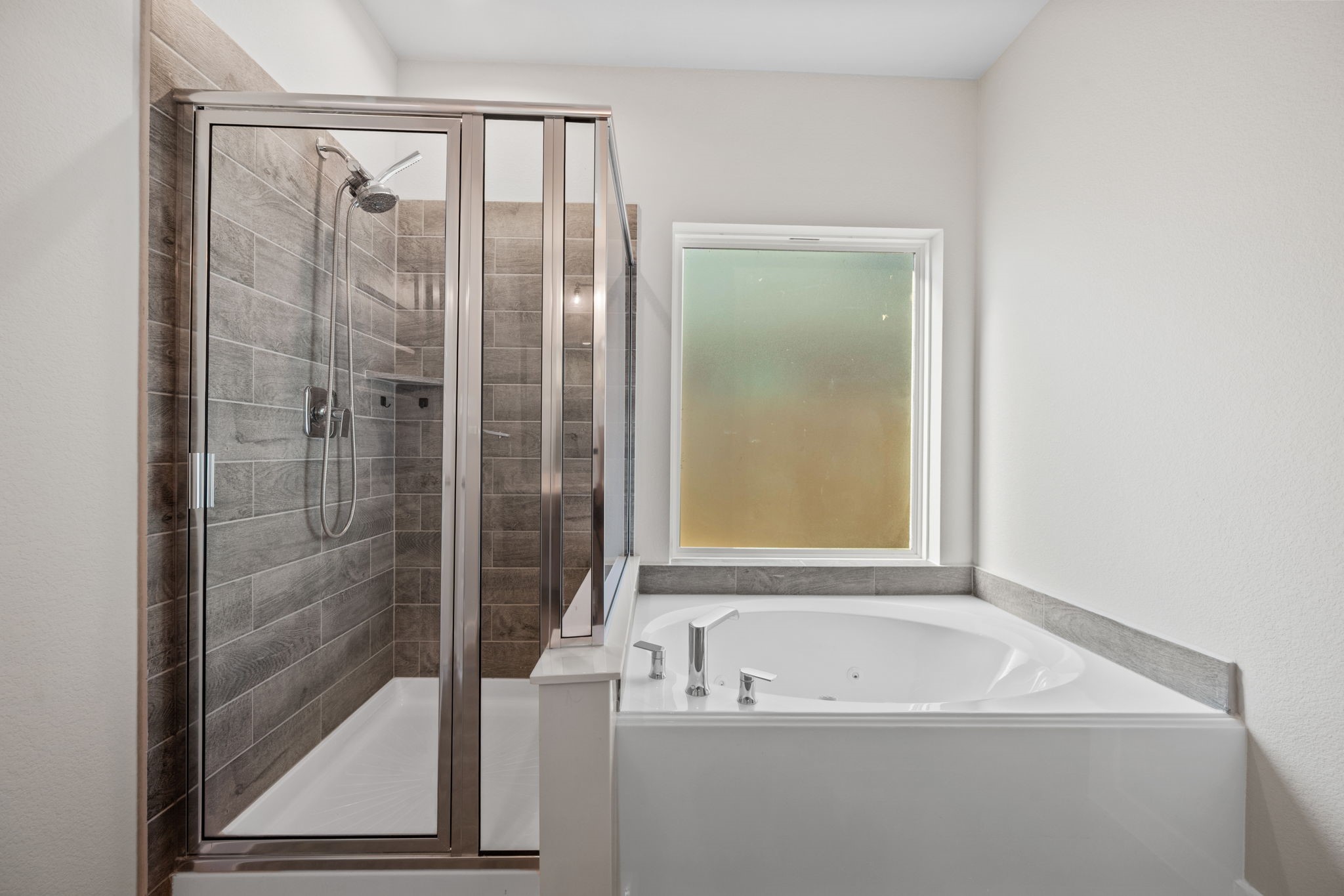 15666 Countesswells Drive Humble, TX 77346 - Photo 13 of 32 a bathroom with a bathtub and shower