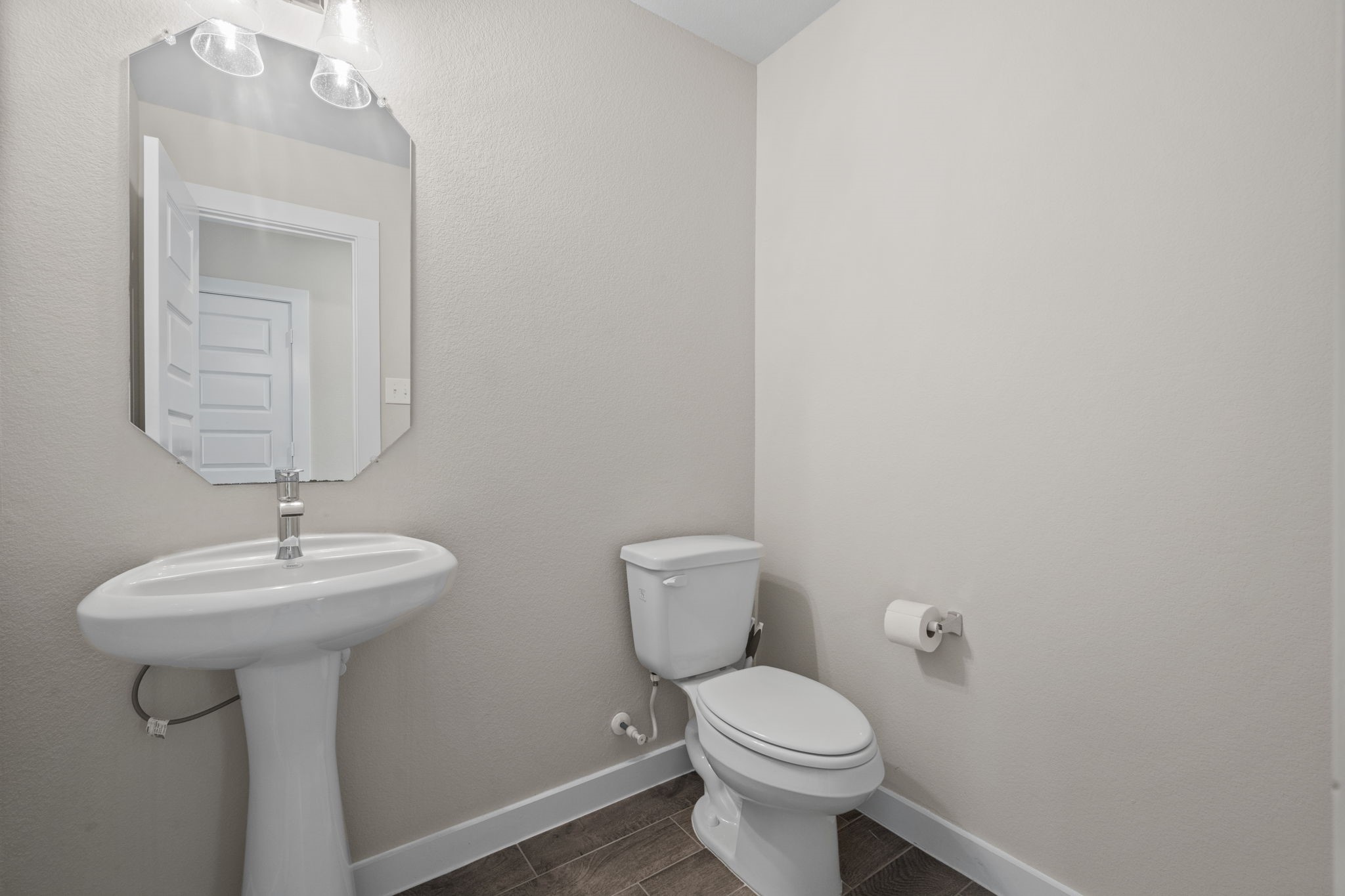 15666 Countesswells Drive Humble, TX 77346 - Photo 15 of 32 a bathroom with a toilet sink and mirror