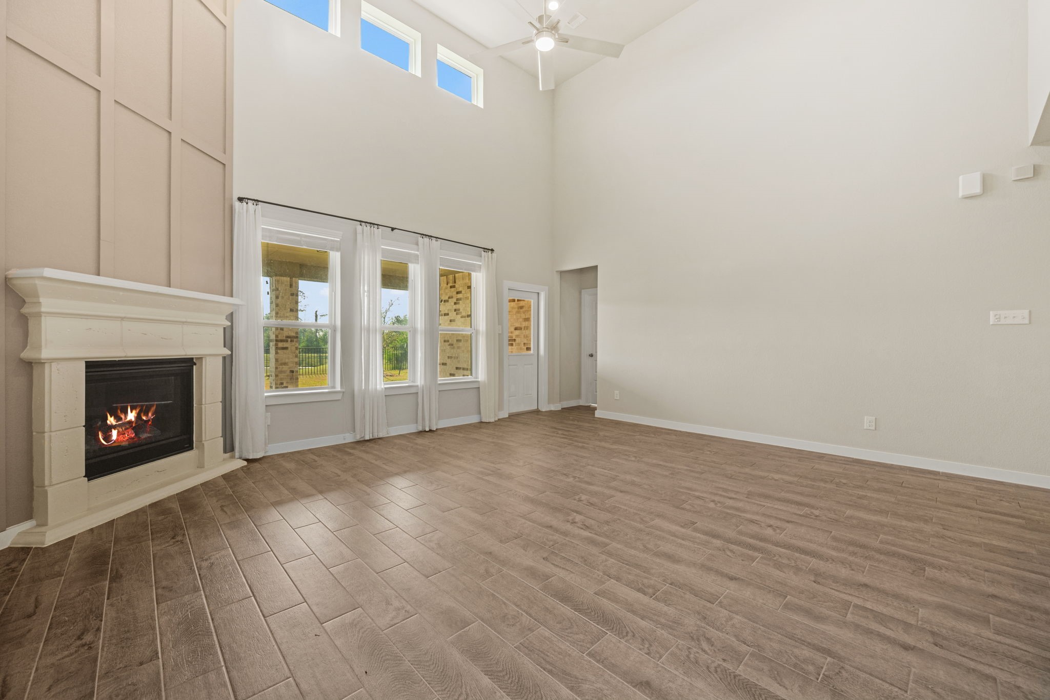 15666 Countesswells Drive Humble, TX 77346 - Photo 16 of 32 a view of an empty room with a fireplace and a window
