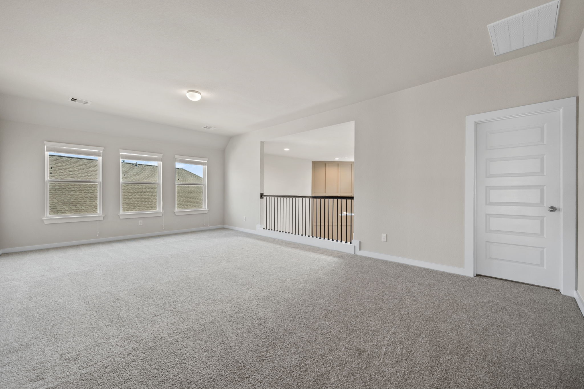 15666 Countesswells Drive Humble, TX 77346 - Photo 30 of 32 a view of an empty room with a kitchen and refrigerator in a kitchen