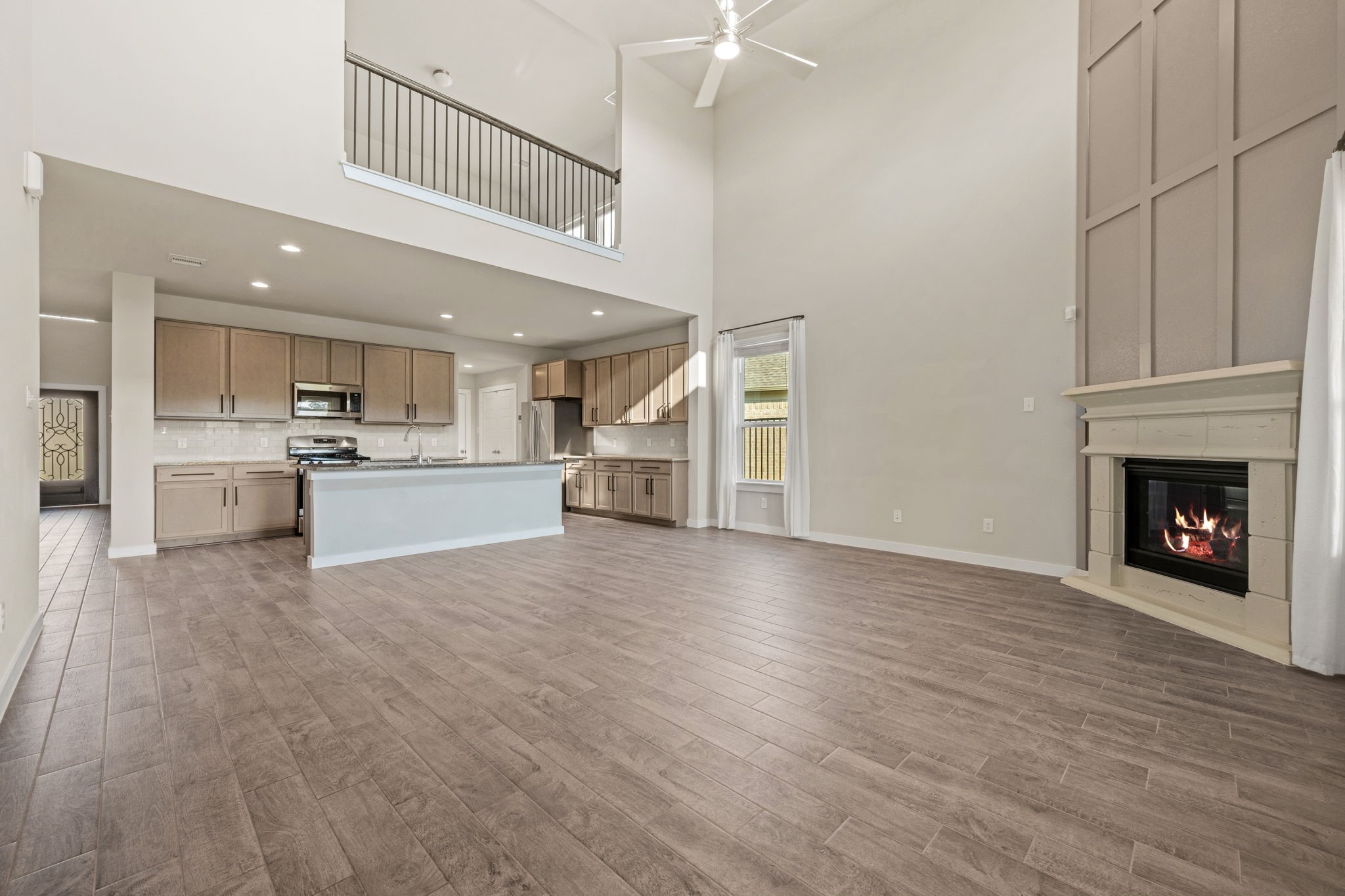 15666 Countesswells Drive Humble, TX 77346 - Photo 8 of 32 a view of a kitchen with a sink a refrigerator and a fireplace