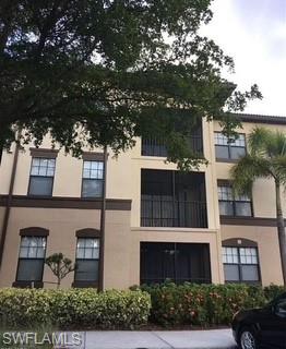 12980 Positano Circle, Unit 207 Naples, FL 34105 - Photo 11 of 23 a view of a building with a garden