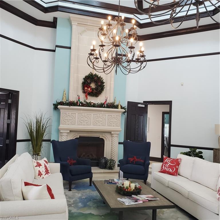 12980 Positano Circle, Unit 207 Naples, FL 34105 - Photo 13 of 23 a living room with furniture and a fireplace