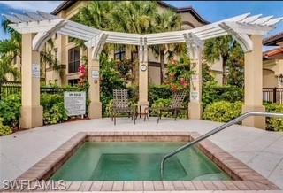 12980 Positano Circle, Unit 207 Naples, FL 34105 - Photo 19 of 23 a view of a patio with table and chairs potted plants