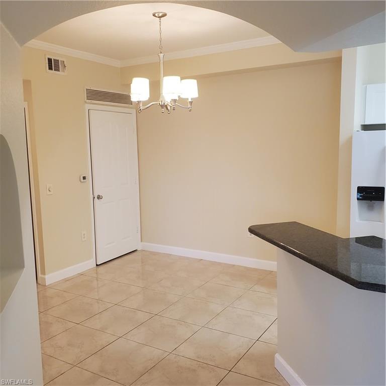 12980 Positano Circle, Unit 207 Naples, FL 34105 - Photo 5 of 23 a view of a kitchen with granite countertop cabinets and a granite counter top