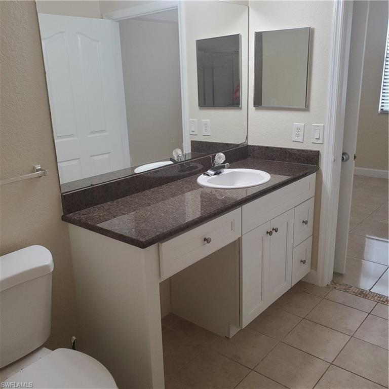 12980 Positano Circle, Unit 207 Naples, FL 34105 - Photo 10 of 23 a bathroom with a sink and a toilet