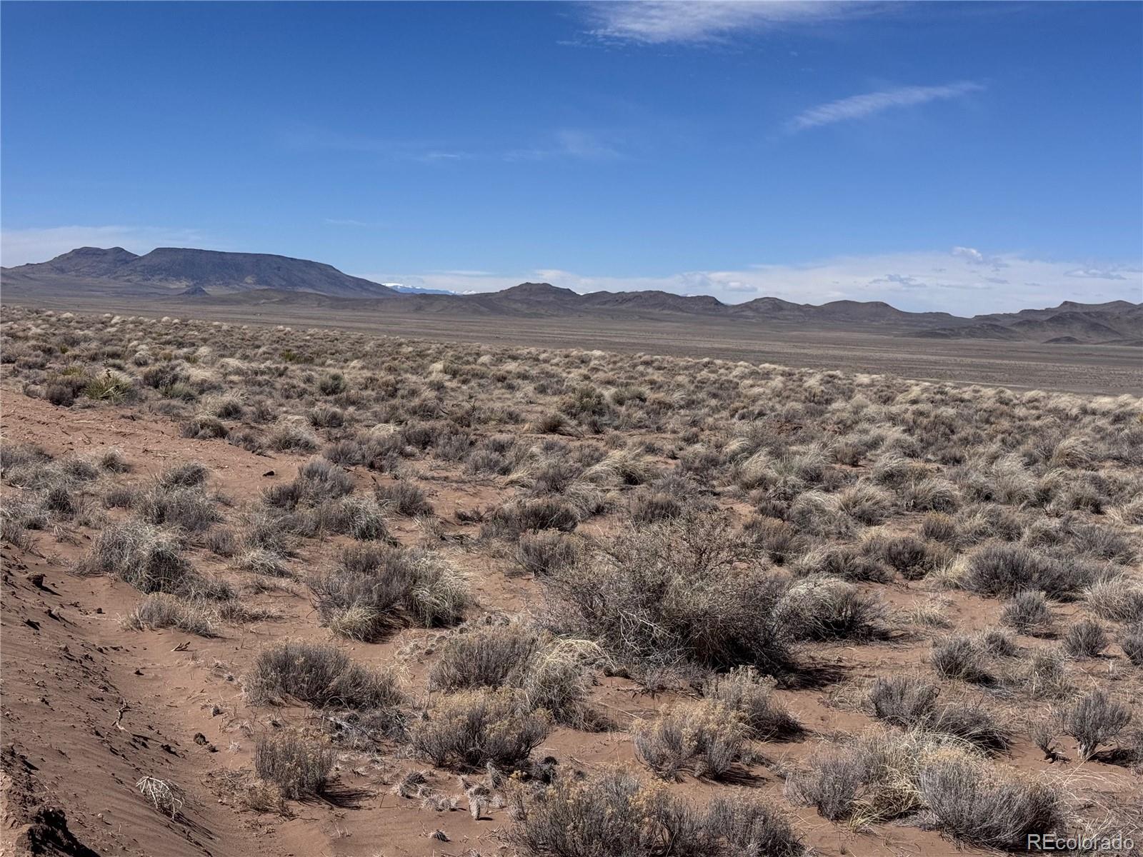 Lot 19 Ana Road Sanford, CO 81151 - Photo 4 of 10 a view of a field with mountains in the background