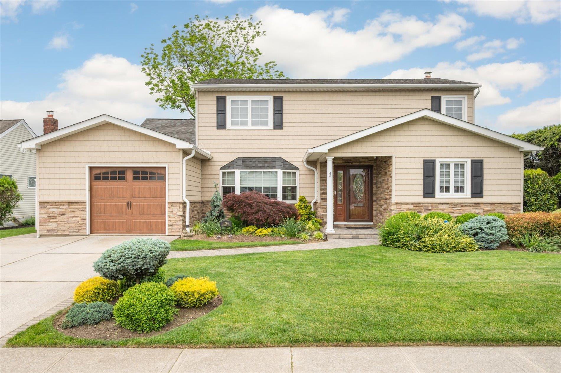 a front view of a house with a yard
