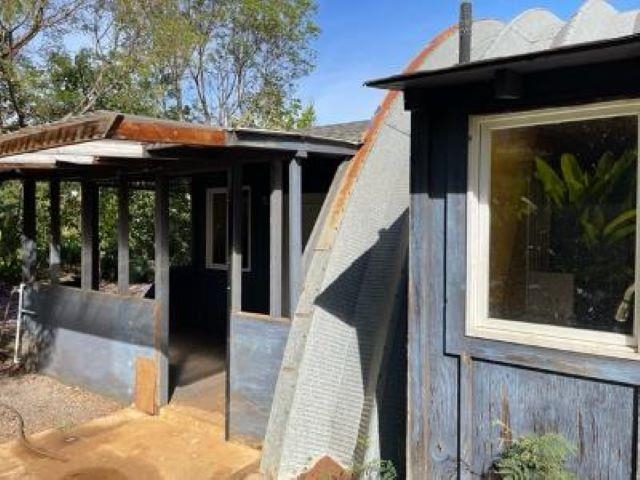 650 Papipi Road Kula, HI 96790 - Photo 12 of 15 a view of patio with a table and chairs under an umbrella with a small yard