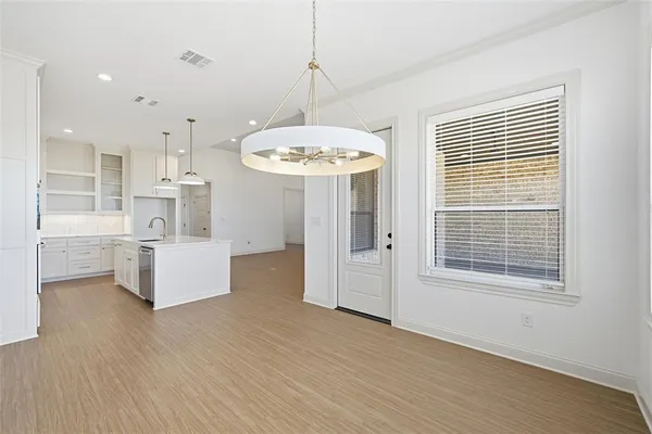 a view of kitchen with windows and refrigerator