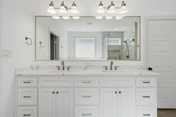 a bathroom with a sink vanity and a mirror
