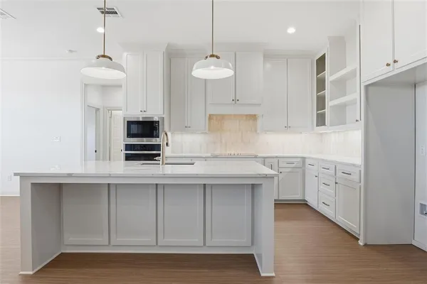 a kitchen with white cabinets and white appliances