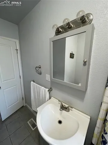 a bathroom with a sink and mirror