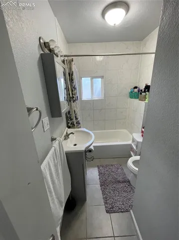 a bathroom with a sink a bathtub and shower