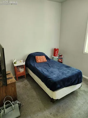 a bed sitting in a room next to a window