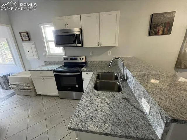 a kitchen with a stove and a sink