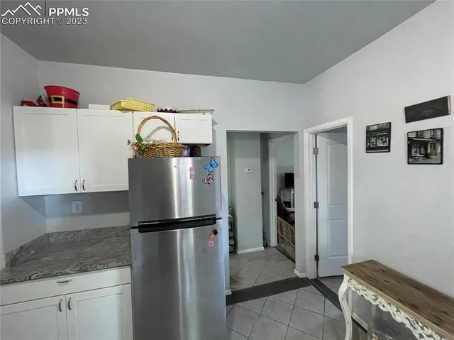a kitchen with a refrigerator and cabinets