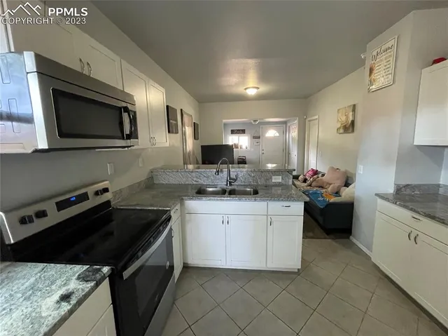 a kitchen with a stove microwave and sink