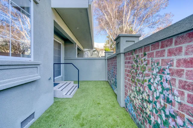 a view of a back yard from a patio
