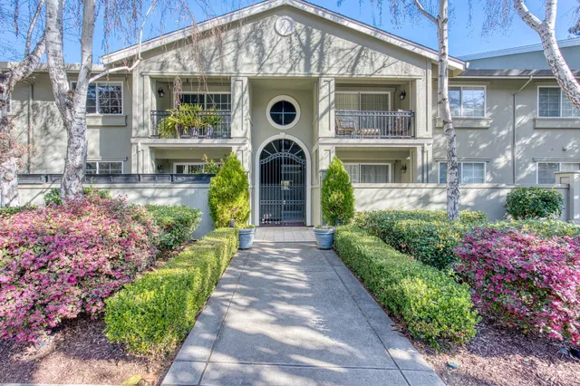 a front view of a house with yard and outdoor seating