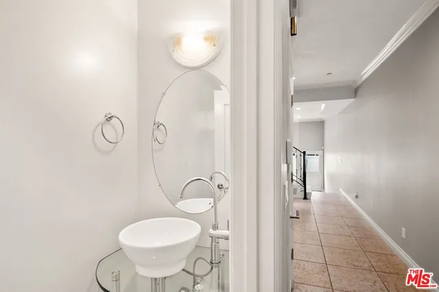 a bathroom with a sink mirror and vanity