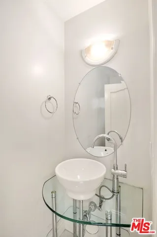 a view of staircase with lots of frames on wall