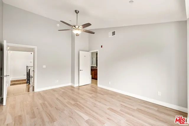a bathroom with a granite countertop sink toilet a large mirror and a shower