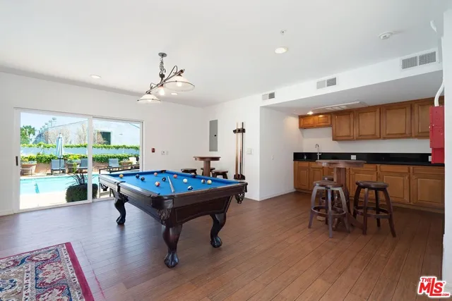 a view of a swimming pool with outdoor seating and a potted plants