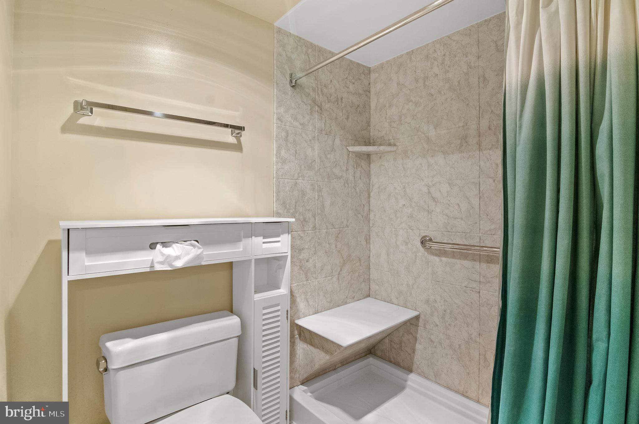 15115 Interlachen Drive, Unit 3506 Silver Spring, MD 20906 - Photo 14 of 27 a bathroom with a toilet a sink and a shower