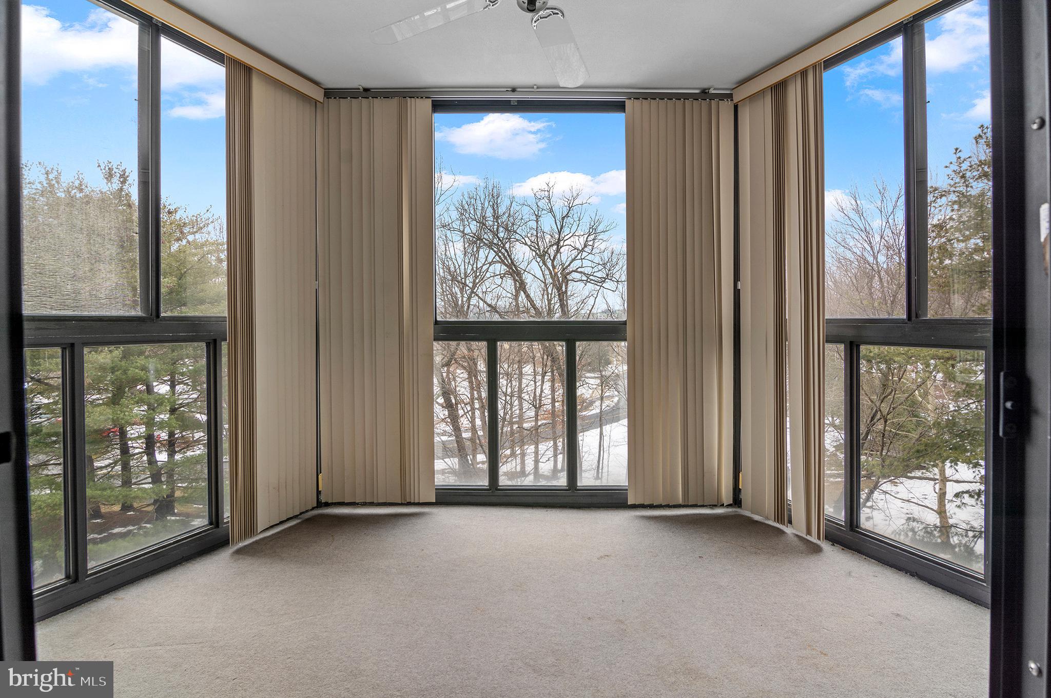 15115 Interlachen Drive, Unit 3506 Silver Spring, MD 20906 - Photo 4 of 27 a view of an empty room with windows and view of balcony