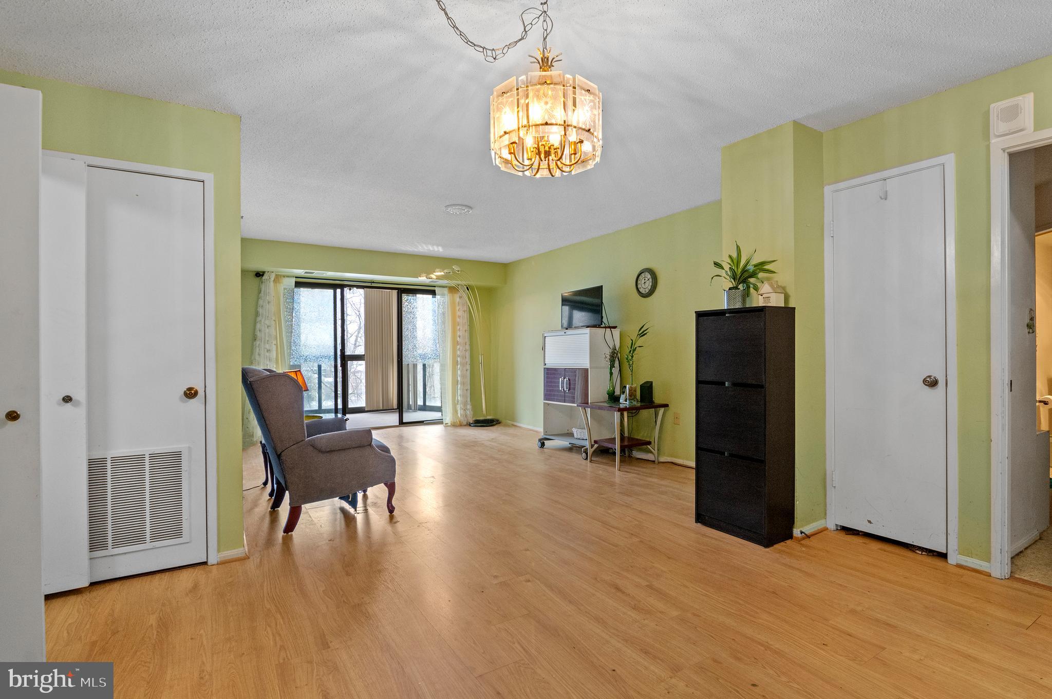 15115 Interlachen Drive, Unit 3506 Silver Spring, MD 20906 - Photo 5 of 27 a view of a livingroom with furniture a dinning room and chandelier