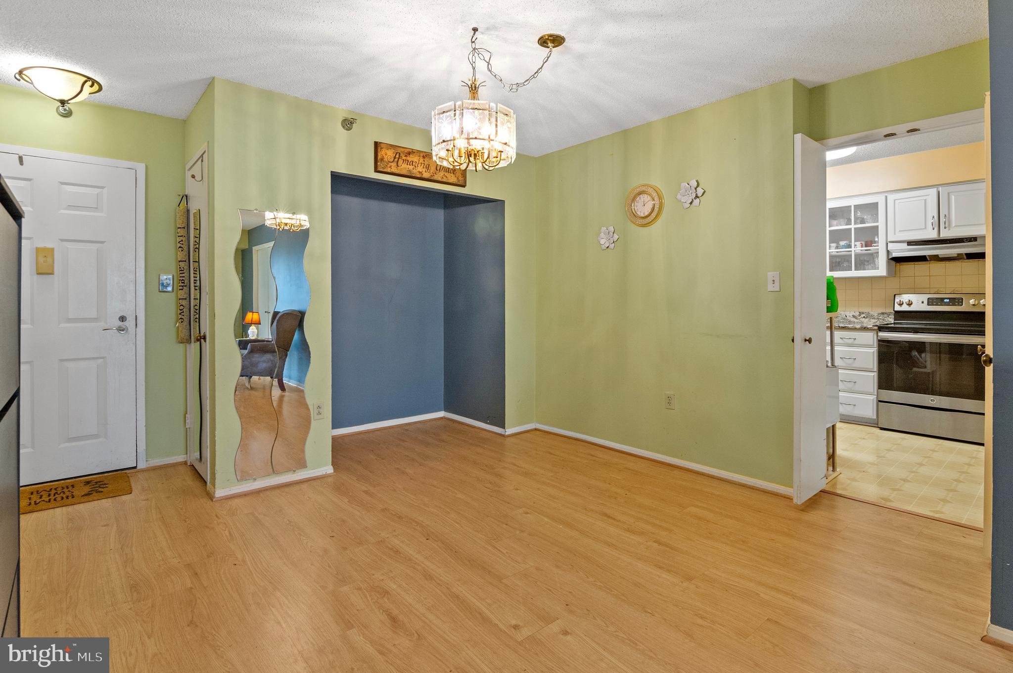 15115 Interlachen Drive, Unit 3506 Silver Spring, MD 20906 - Photo 6 of 27 a view of a kitchen with a refrigerator a stove top oven and a kitchen view