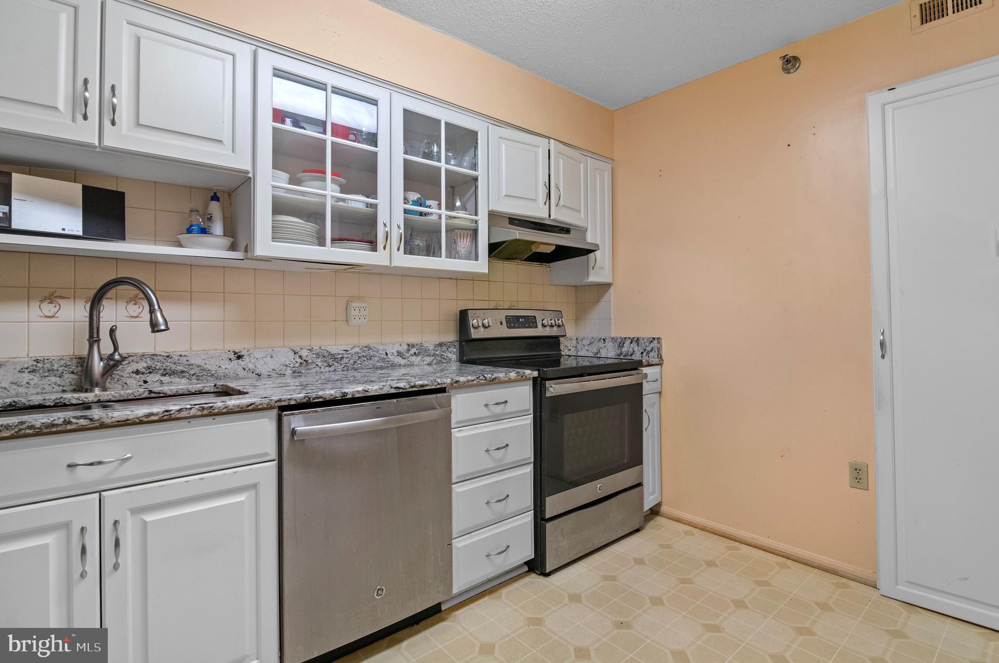 15115 Interlachen Drive, Unit 3506 Silver Spring, MD 20906 - Photo 10 of 27 a kitchen with stainless steel appliances granite countertop a stove and a sink