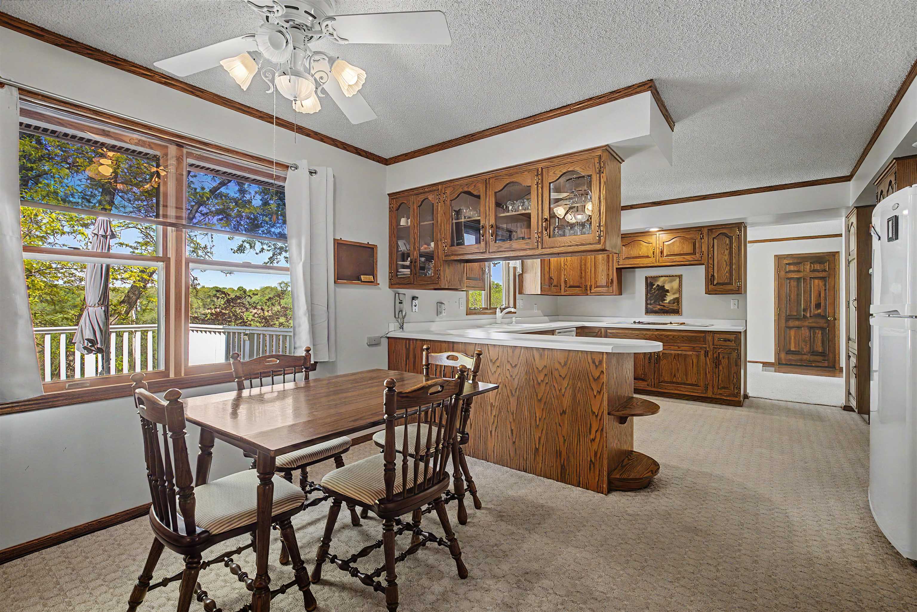 17380 Corbett Road Mount Carroll, IL 61053 - Photo 5 of 65 a dining room with stainless steel appliances kitchen island granite countertop furniture and a large window