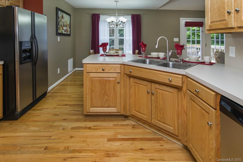 3474 Mack Ballard Road Maiden, NC 28650 - Photo 5 of 24 a kitchen with stainless steel appliances a sink cabinets and wooden floor