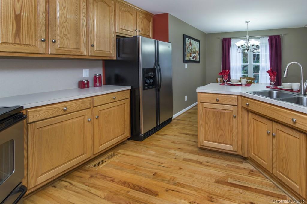 3474 Mack Ballard Road Maiden, NC 28650 - Photo 7 of 24 a kitchen with stainless steel appliances granite countertop a refrigerator sink and cabinets