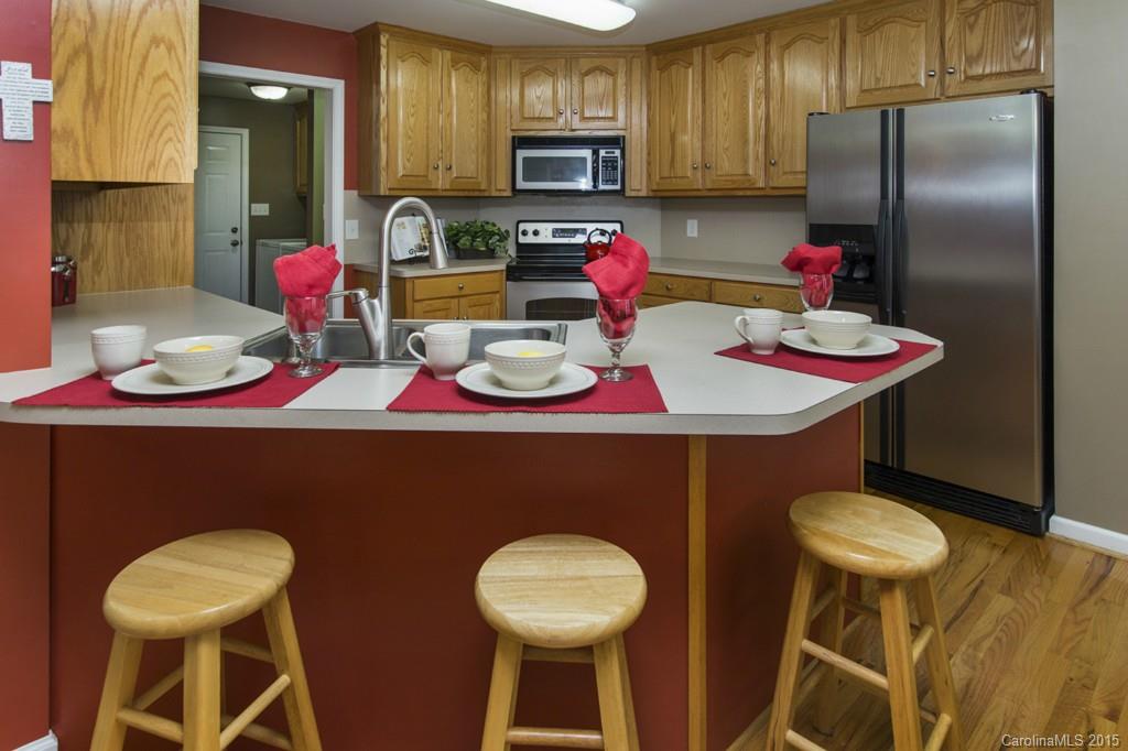 3474 Mack Ballard Road Maiden, NC 28650 - Photo 8 of 24 a kitchen with stainless steel appliances granite countertop a dining table chairs and a refrigerator