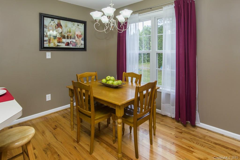 3474 Mack Ballard Road Maiden, NC 28650 - Photo 9 of 24 a view of a dining room with furniture a chandelier and wooden floor