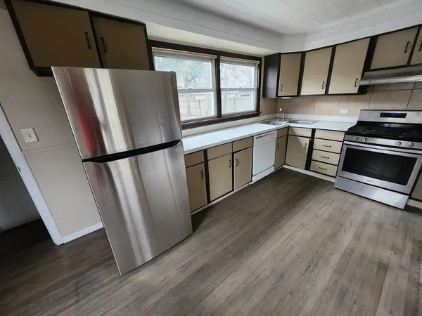 a kitchen with a refrigerator a sink and a stove