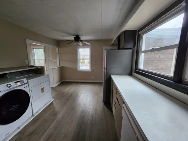 a view of kitchen and bathroom with wooden floor