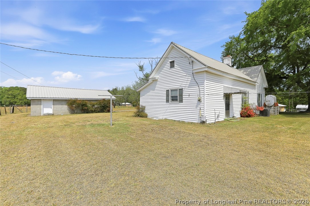 249 Nicholson Road Rockingham, NC 28379 - Photo 7 of 47 a view of a house with a yard and garage