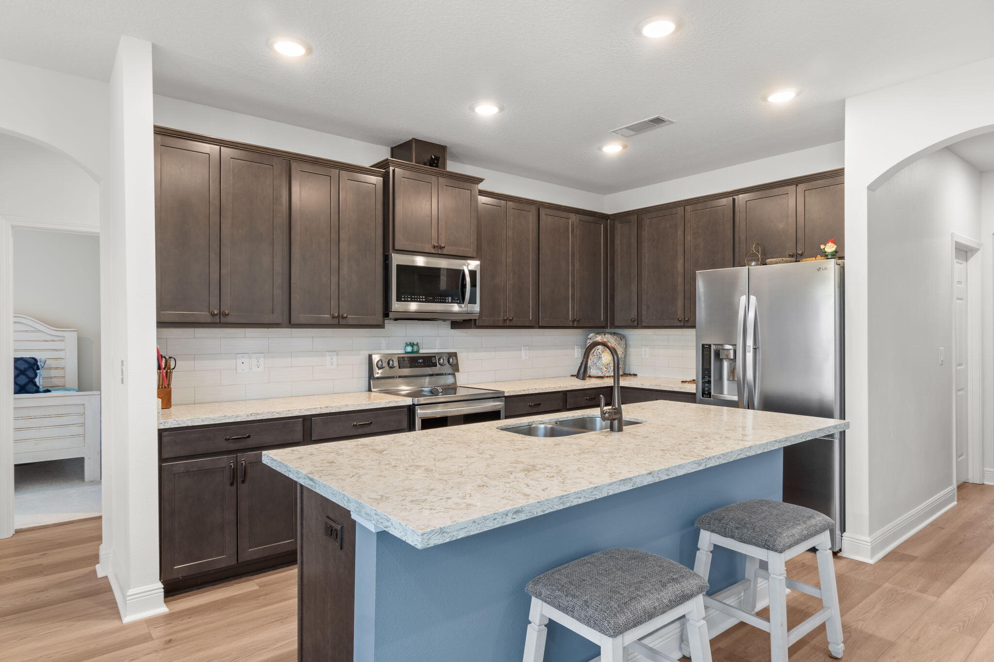 369 Brushed Dune Circle Freeport, FL 32439 - Photo 17 of 63 a kitchen with kitchen island a sink refrigerator and cabinets
