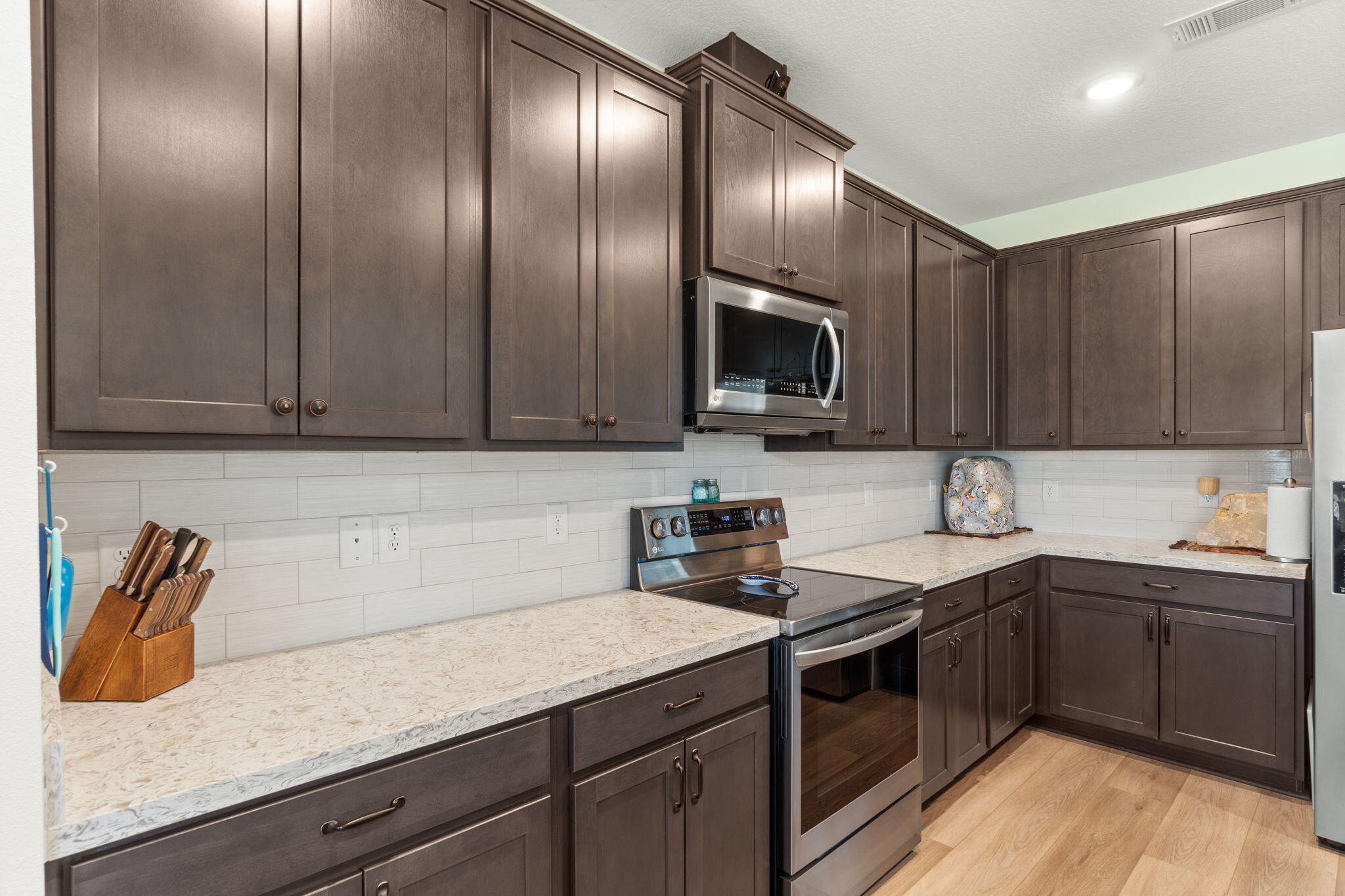 369 Brushed Dune Circle Freeport, FL 32439 - Photo 18 of 63 a kitchen with stainless steel appliances granite countertop a sink stove and microwave
