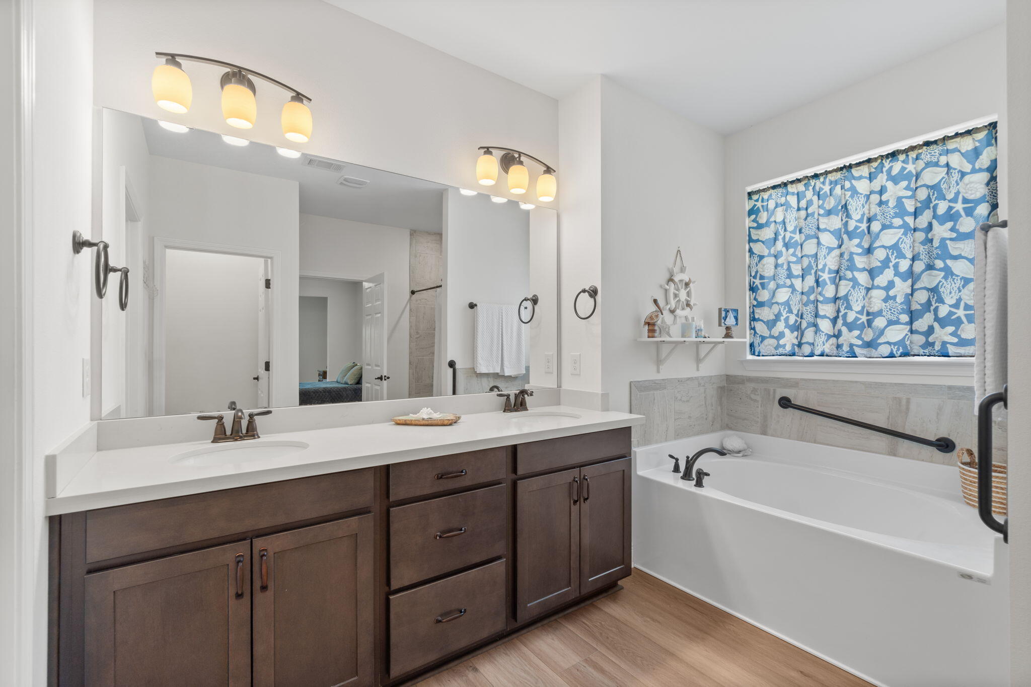 369 Brushed Dune Circle Freeport, FL 32439 - Photo 36 of 63 a bathroom with a tub sink and mirror