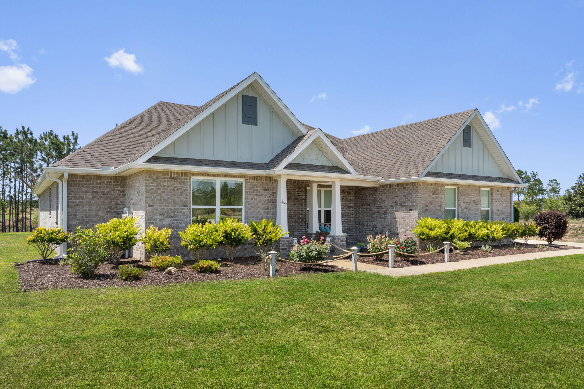 369 Brushed Dune Circle Freeport, FL 32439 - Photo 4 of 63 a front view of house with yard and outdoor seating