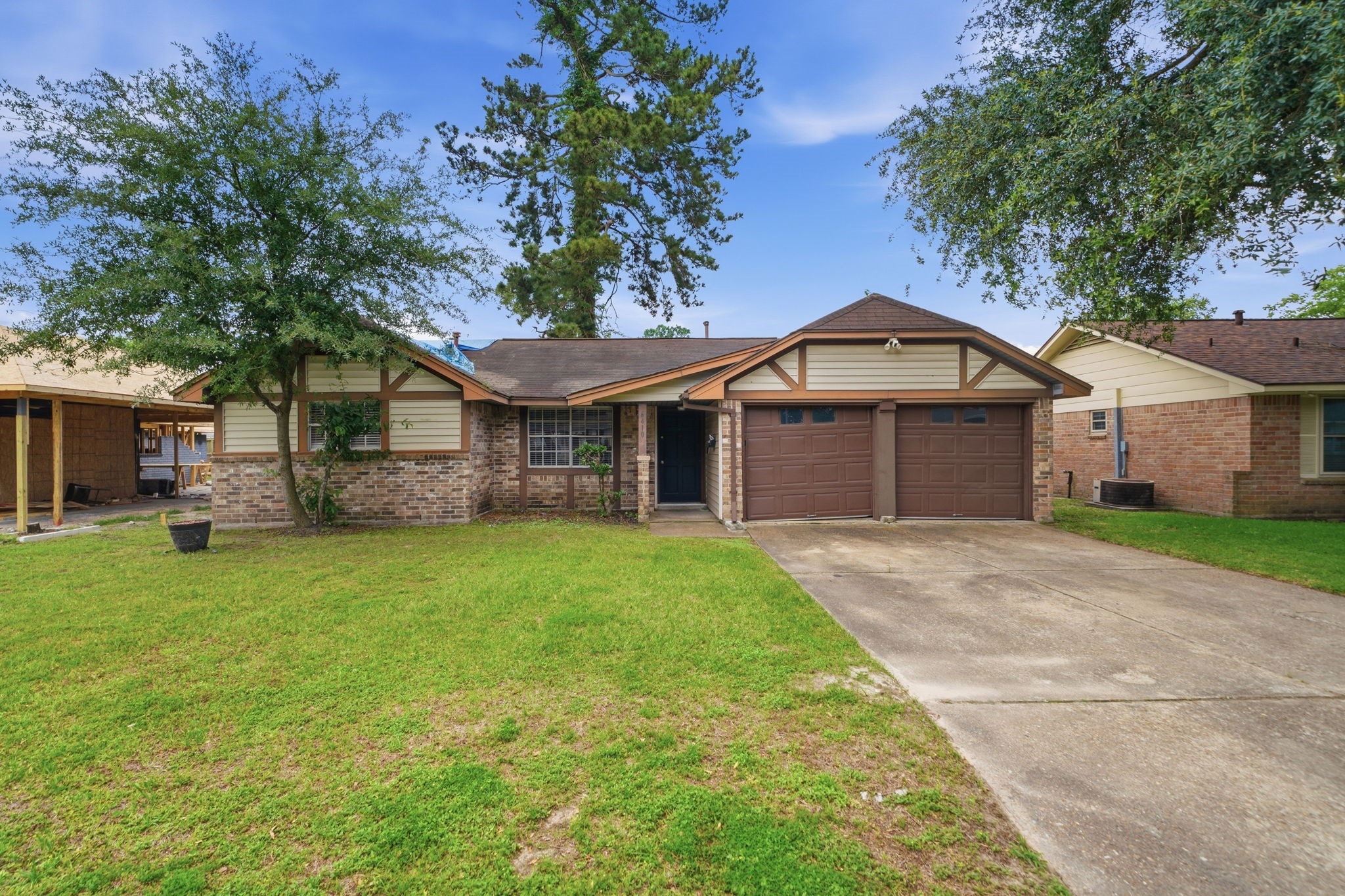 6410 Hopper Road Houston, TX 77016 - Photo 1 of 28 a front view of a house with a garden