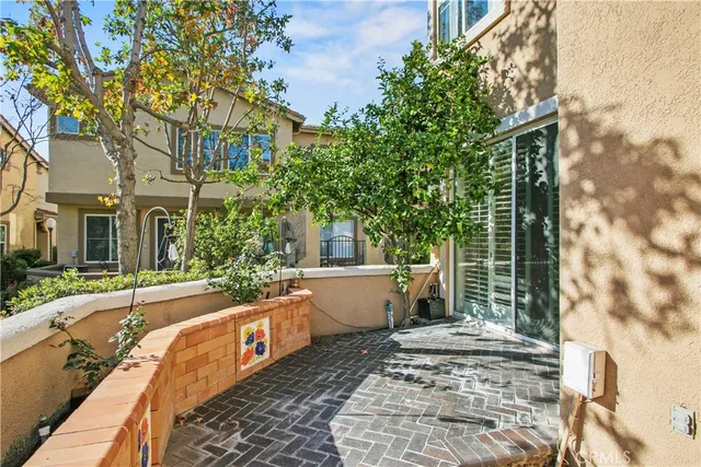 a view of a house with backyard and sitting area