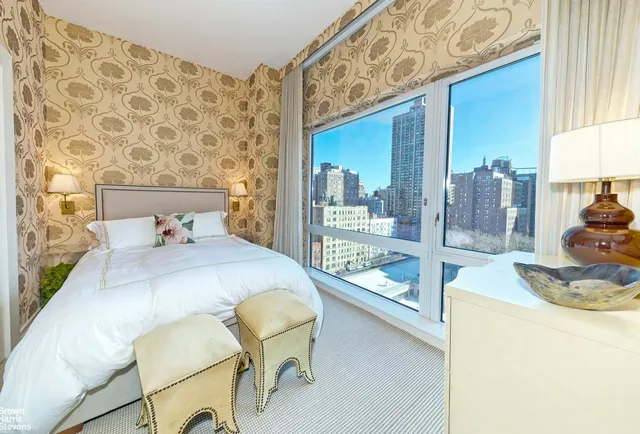 a dining room with furniture and a floor to ceiling window