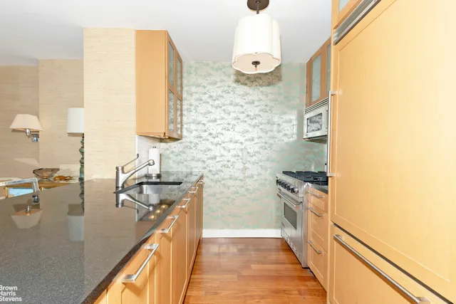 a kitchen with a sink stove and refrigerator